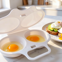 Open white two-cavity egg steamer with eggs beside avocado toast