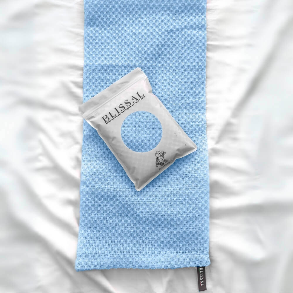 Blue exfoliating back towel laid flat