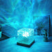Blue water ripple cube lamp glowing on a desk