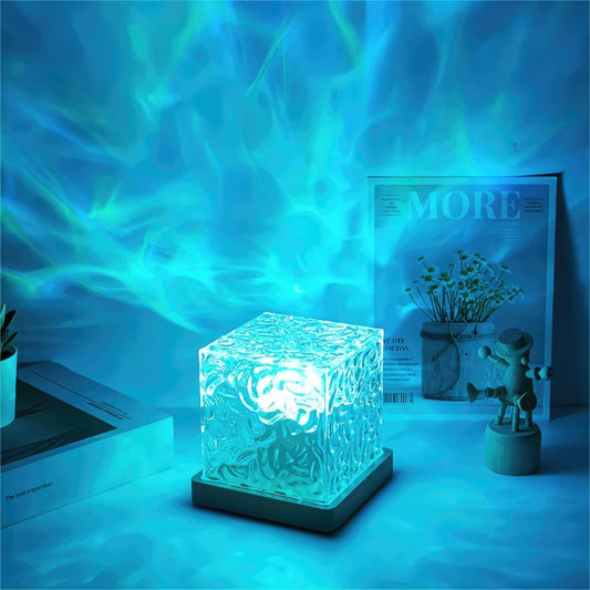 Blue water ripple cube lamp glowing on a desk