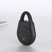 Black loop-topped rechargeable keychain device shown upright on a light background with a circular ridged front panel
