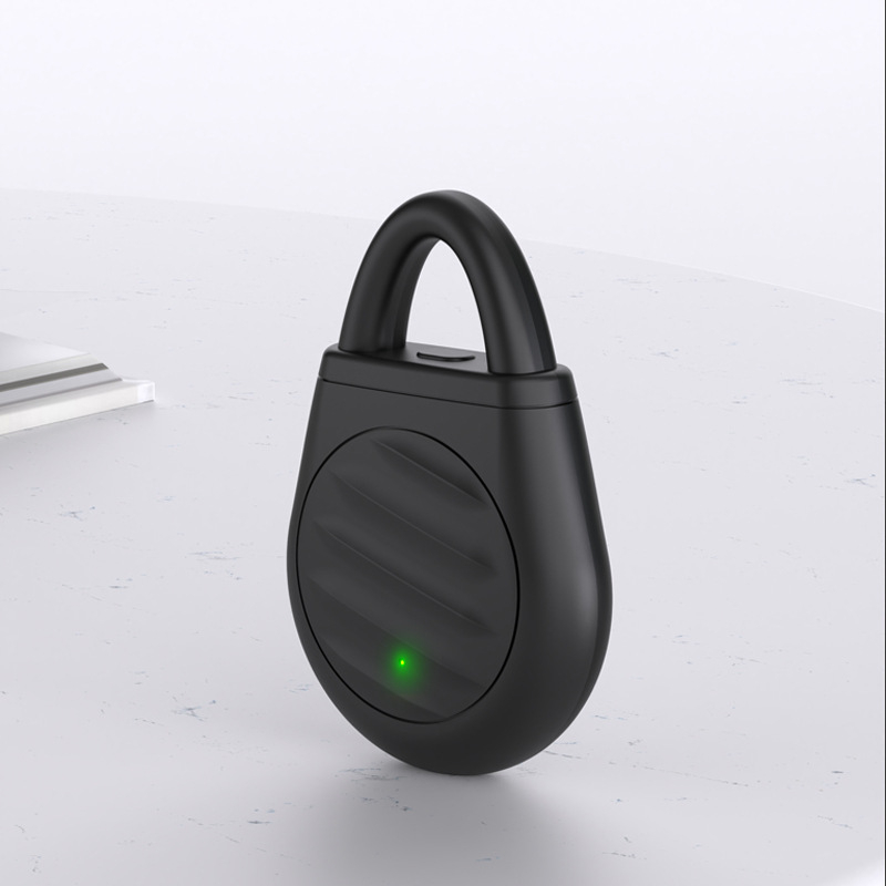 Black loop-topped rechargeable keychain device shown upright on a light background with a circular ridged front panel