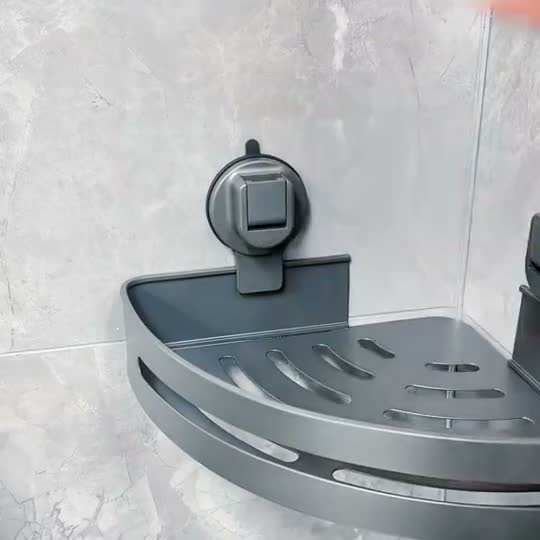 Close view of the slotted base and raised front rail on a gunmetal triangular shower caddy