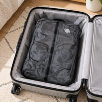 Black vacuum travel bag inside an open carry-on suitcase